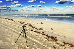 Uninhabited Coastline Images Prints: Old camera on the sandy beach