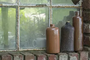 Rustic Country Style Decor Prints: Three old earthenware bottles in front of a stable window