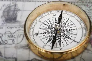 Studio Compass Shot Prints: Old fashioned compass on an antique map