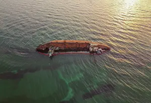 Environmental Pollution Prints: The old rusty ship was stranded by a storm