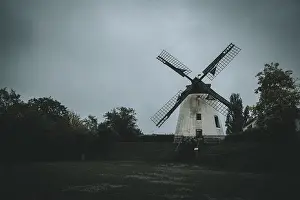 Cloudy Daytime Scene Prints: An old windmill on a cloudy day