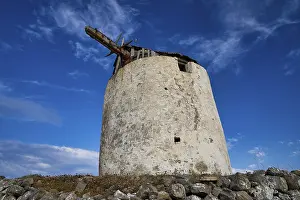 Aegean Sea Landscape Photography Prints: Old windmill tower against a deep blue sky with clouds