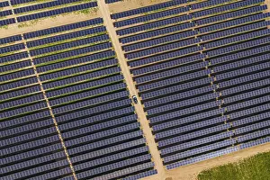 Agri PV Germany Prints: Overview of solar panel fields with a car on a dirt path