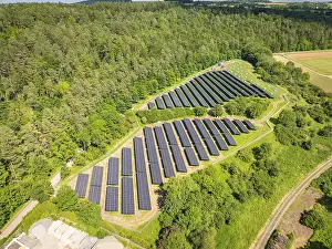 German Renewable Energy Prints: Overview of a solar panel landscape surrounded by lush forests and open fields