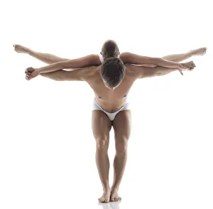 White Background Acrobatics Prints: Pair of acrobats doing trick in studio