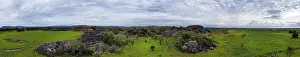 Top Down View Of Rock Formations Prints: Panoramic view of green landscape and dramatic rocks under a cloudy sky