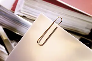 Office Stationery Supplies Prints: Paperclip, paper clips in front of a stack of files