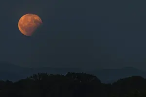 Lunar Eclipse Photography Prints: Partial lunar eclipse, the shadow of the earth is projected onto the moon