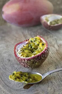 Tropical Fruit Prints: A passion fruit, opened with pulp on a spoon