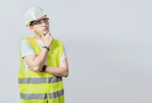 Low Angle View Photography Prints: A pensive engineer on white background