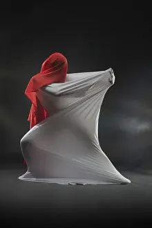 Elegant Ballet Performance Prints: A performer is wrapped in flowing white and red fabrics in a dramatic studio setting