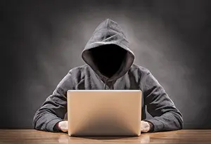 Data Security Threats Prints: picture of a hacker on a computer