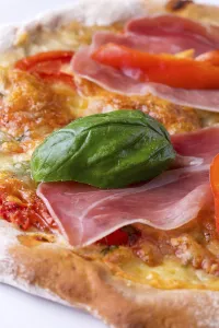 Deserted Food Photography Prints: Detail of a pizza with ham and basil