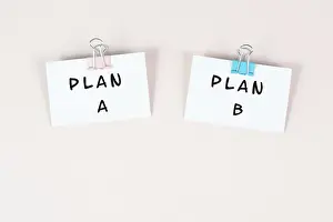 No People In The Background Prints: Plan A and B standing on paper