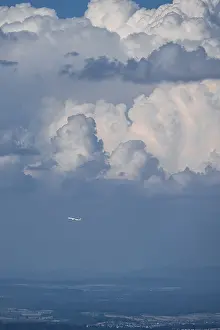 Dramatic Clouds Europe Prints: Plane in front of dramatic clouds, Switzerland