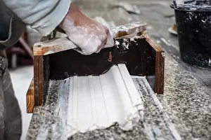 Traditional Craftsman Work Prints: A plasterer creates a stucco profile