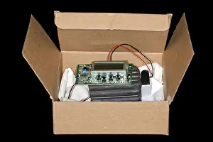 Power Supply Equipment Prints: Plastic explosive with timer and battery lies in a box