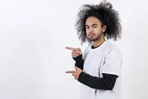 Hispanic Ethnicity Male Model Prints: Pointing to the left at a copy paste space