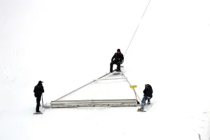 Ski Jumping World Cup Prints: Using an oversized rake attached to a cable winch