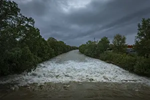 Cloudy Sky Austria Prints: A powerful river with a strong current under a cloudy sky