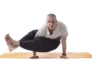 White Studio Photo Prints: Practicing yoga trainer posing looking at camera