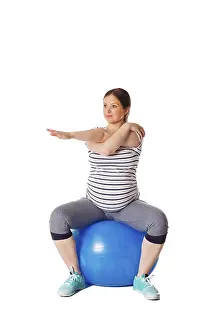 White Background Gymnastics Prints: Pregnancy exercise concept, pregnant woman doing stretching exercises with exercise ball isolated on white background