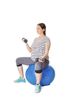 Pregnancy Exercise Prints: Pregnancy exercise concept, pregnant woman doing exercises with exercise ball and barbells isolated on white background