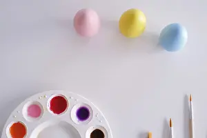 Traditional Easter Depiction Prints: Preparing for Easter. Painting easter eggs on colorful tablecloth background
