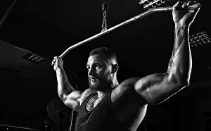 Professional Athlete Training Prints: Professional athlete performs an exercise in the gym