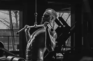 Gym Equipment Use Prints: Professional athlete performs an exercise in the gym