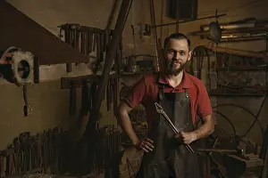 Handicraft Industry Prints: Professional blacksmith in workshop portrait
