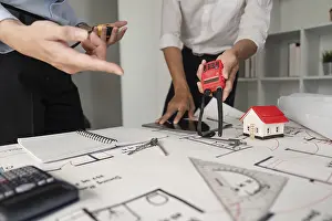Building Inspection Prints: Two professionals examine construction plans