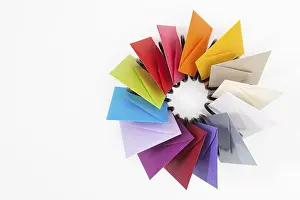 White Table Studio Shot Prints: Propeller of colored envelopes on the white table