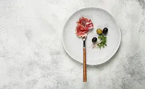 Gourmet Snack Meal Prints: Prosciutto on a fork, top view