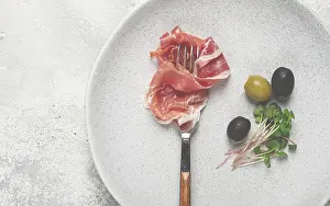 Italian Cuisine Image Prints: Prosciutto on a fork, top view