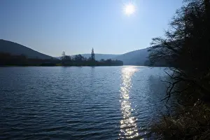 Hilly Countryside Europe Prints: A quiet river on which the sun is reflected