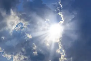 Sunbeams Through Clouds Prints: Rain clouds with sun shining through