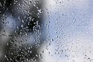 Cloudy Sky With Raindrops Prints: Rain drops on window as the clouds clear behind