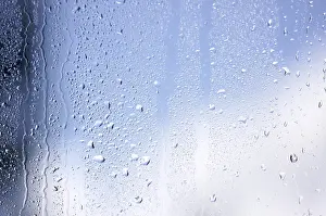 Cloudy Sky With Raindrops Prints: Rain drops on window as the clouds clear behind