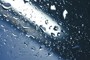 Atmospheric Light Effect Prints: Rain drops on window glasses surface with sunset