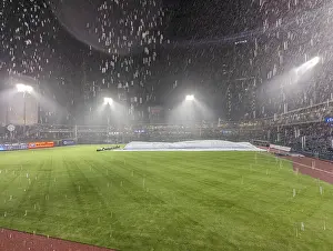 Baseball Stadium Prints: Rain and thunder at baseball stadium during game Print