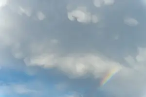 Prismatic Colors In Spring Prints: Rainbow appears in rain clouds in spring