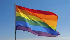 Rainbow Flag Symbol Prints: The rainbow flag flutters in the wind