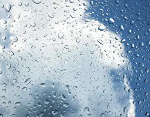 Raindrops On Window Prints: Raindrops on a window in front of storm clouds