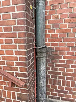 Images Dated 4th February 2024: Rainwater Downpipe in Brick Wall Ceiling Print