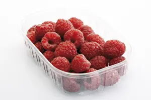 Cut Out Raspberry Images Prints: Raspberries in a plastic storage container