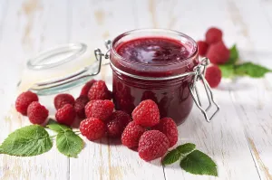 Breakfast Dessert Ideas Prints: Raspberry jam with fresh berries on a white table