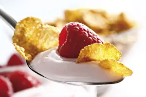 Deserted Breakfast Table Setup Prints: Raspberry yoghurt with cornflakes on a spoon