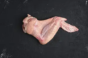 Raw Turkey Wing Prints: Raw turkey wing on black background