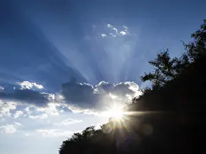 Empty Austrian Landscapes Prints: Rays of sunshine breaking through clouds